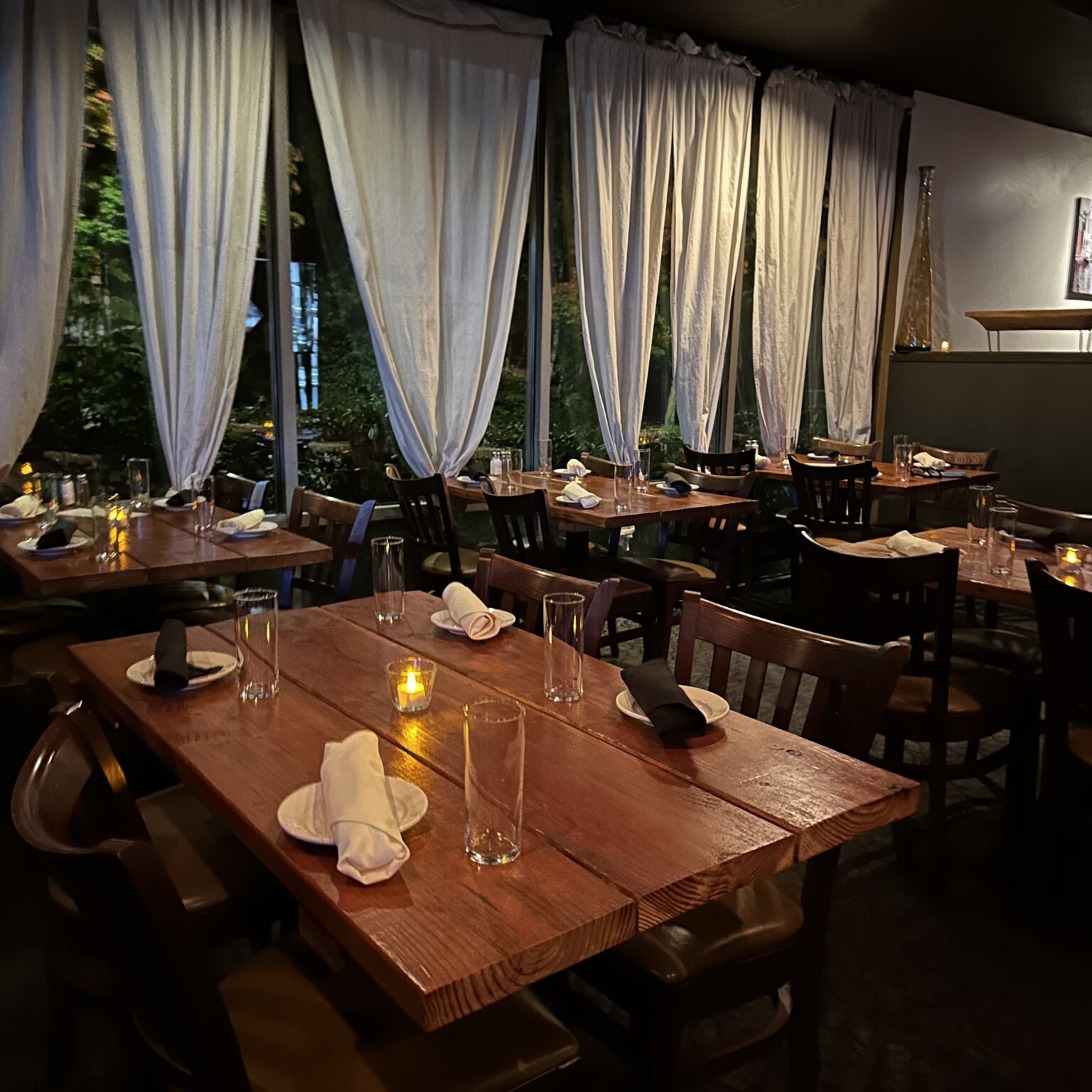 Warm dining room and set tables at Gino’s Pizza, Pasta & Co.